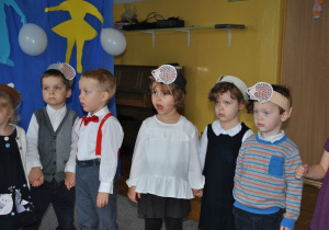 Kilkoro dzieci stoi. Na głowach mają założone opaski z symbolem jeża. Ujęcie 2